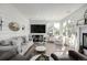 Cozy living room with shiplap walls, fireplace, large windows, and comfortable seating arrangements at 9683 Las Colinas Dr, Lone Tree, CO 80124