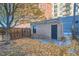 Backyard space with a brick structure, fenced perimeter, and fall foliage at 1650 N Pennsylvania St, Denver, CO 80203