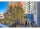 Overhead view of a brick structure, fence perimeter, and colorful tree in the yard at 1650 N Pennsylvania St, Denver, CO 80203