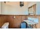 Vintage bathroom with wood paneling, marble sink, period fixtures, and classic charm at 1650 N Pennsylvania St, Denver, CO 80203