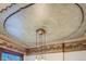 Ornate ceiling detail with decorative molding, ceiling medallion, and hanging light fixture at 1650 N Pennsylvania St, Denver, CO 80203