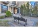 Exterior elevation with covered porch, columns, bench and professionally landscaped front yard at 1650 N Pennsylvania St, Denver, CO 80203