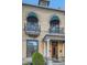 Charming brick home exterior featuring arched windows, balconies and decorative awnings at 1650 N Pennsylvania St, Denver, CO 80203