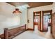 Second floor hallway with decorative chandelier and original wood trim and doors at 1650 N Pennsylvania St, Denver, CO 80203