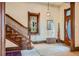 Hallway featuring a wooden staircase, stained glass window, and hardwood trim at 1650 N Pennsylvania St, Denver, CO 80203