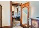 View into a refined office space through a vintage carved wood door at 1650 N Pennsylvania St, Denver, CO 80203