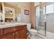 Bright bathroom featuring a glass-enclosed shower, tile floors, and a wood vanity at 2116 Ridgetrail Dr, Castle Rock, CO 80104