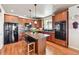 Well-equipped kitchen with stainless steel appliances, wood cabinets, and a center island at 2116 Ridgetrail Dr, Castle Rock, CO 80104