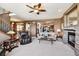 Open living room showcasing a stone fireplace and seamless flow to the kitchen at 2116 Ridgetrail Dr, Castle Rock, CO 80104