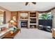 Comfortable living room featuring a stone fireplace, built-in shelves, and neutral decor at 2116 Ridgetrail Dr, Castle Rock, CO 80104