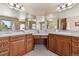 Elegant main bathroom features dual sinks, abundant vanity counter space, and large mirrors at 2116 Ridgetrail Dr, Castle Rock, CO 80104