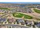 Wide aerial shot showcasing the property's location within a golf course community with water features at 8233 E 149Th Dr, Thornton, CO 80602