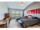 Bedroom with two twin beds, dresser, and large window providing natural light at 8233 E 149Th Dr, Thornton, CO 80602