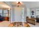 Bright entryway with hardwood floors, a white front door, and a decorative chandelier at 8233 E 149Th Dr, Thornton, CO 80602