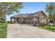 Charming single-story home with a spacious driveway and beautiful landscaping, perfect for comfortable living at 8233 E 149Th Dr, Thornton, CO 80602