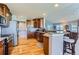 Modern kitchen with stainless steel appliances, granite countertops, and rich wood cabinetry at 8233 E 149Th Dr, Thornton, CO 80602
