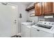 A modern laundry room featuring a front loading washer and dryer at 8233 E 149Th Dr, Thornton, CO 80602