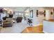 Open-concept living room featuring hardwood floors, comfortable seating, and ample natural light at 8233 E 149Th Dr, Thornton, CO 80602