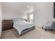 Neutral bedroom features carpet, and bed with a tufted headboard, and dresser at 350 Mesa Ave, Lochbuie, CO 80603