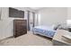 Bedroom features bed, dresser, large window and TV at 350 Mesa Ave, Lochbuie, CO 80603