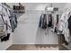Walk in closet featuring hanging clothes, shelves, carpet and white walls at 350 Mesa Ave, Lochbuie, CO 80603