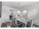 Bright dining room featuring a wood table with seating for six, a decorative rug, and modern lighting at 350 Mesa Ave, Lochbuie, CO 80603