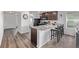 Well-designed kitchen with dark wood cabinets, granite countertops, stainless steel appliances, and bar stool seating at 350 Mesa Ave, Lochbuie, CO 80603
