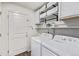 Functional laundry room features efficient washer and dryer, and built-in storage at 350 Mesa Ave, Lochbuie, CO 80603