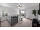 Cozy living room with neutral carpet, ample seating, ceiling fan, and natural light from sliding glass doors at 350 Mesa Ave, Lochbuie, CO 80603