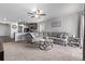 Comfortable living room with gray sectional sofa, ceiling fan and an open layout to kitchen at 350 Mesa Ave, Lochbuie, CO 80603