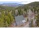 Secluded cabin nestled in a dense forest setting with stunning mountain views at 356 Castlewood Dr, Evergreen, CO 80439