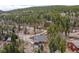 A-frame style house nestled in wooded area with a long dirt driveway at 356 Castlewood Dr, Evergreen, CO 80439