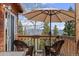 Relax on the back porch with comfortable seating and views of the scenic landscape at 356 Castlewood Dr, Evergreen, CO 80439