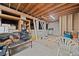 Unfinished basement with exposed beams and a ladder, offering potential for customization at 356 Castlewood Dr, Evergreen, CO 80439