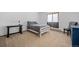 Bright bedroom with carpet floors, a white wooden frame bed, neutral colored bedding and a window at 356 Castlewood Dr, Evergreen, CO 80439