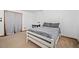 Bright bedroom with carpet floors, a white wooden frame bed, neutral colored bedding and a window at 356 Castlewood Dr, Evergreen, CO 80439