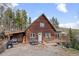 Charming wood home with a cozy front porch and landscaped front, perfect for outdoor gatherings at 356 Castlewood Dr, Evergreen, CO 80439