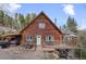 Charming wood home with a cozy front porch and landscaped front, perfect for outdoor gatherings at 356 Castlewood Dr, Evergreen, CO 80439