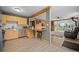 Open concept living area with bar seating connecting the kitchen, living room, and stunning mountain views at 356 Castlewood Dr, Evergreen, CO 80439