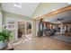 Open-concept living space with a cozy fireplace and seamless access to a covered deck, blending indoor and outdoor living at 356 Castlewood Dr, Evergreen, CO 80439