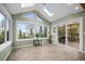 Bright sunroom with large windows and sliding glass doors leading to a deck at 356 Castlewood Dr, Evergreen, CO 80439