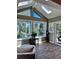 Bright sunroom features skylights, large windows with stunning views, and beautiful wood-look floors at 356 Castlewood Dr, Evergreen, CO 80439