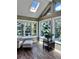 Bright sunroom features skylights, large windows with beautiful views, and wood-look floors at 356 Castlewood Dr, Evergreen, CO 80439