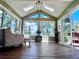 Bright sunroom features skylights, large windows with stunning views, and beautiful wood-look floors at 356 Castlewood Dr, Evergreen, CO 80439