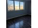 The bedroom has wood-look floors and a three-pane window at 2225 Buchtel Blvd # 207, Denver, CO 80210