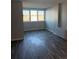 The bedroom has wood-look floors and a three-pane window providing natural light at 2225 Buchtel Blvd # 207, Denver, CO 80210