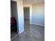 Hallway between rooms with wood-look floors and gray walls at 2225 Buchtel Blvd # 207, Denver, CO 80210