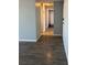 Hallway showing hardwood floors and bathroom with shower and tub at 2225 Buchtel Blvd # 207, Denver, CO 80210