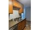 Kitchen with new stainless steel sink and wood cabinets at 2225 Buchtel Blvd # 207, Denver, CO 80210