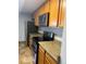 Kitchen with stainless steel refrigerator, oven, microwave and wood cabinets at 2225 Buchtel Blvd # 207, Denver, CO 80210